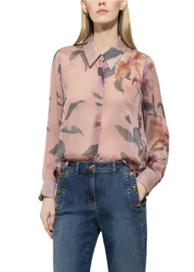 Person wearing a floral blouse and blue jeans on a white background