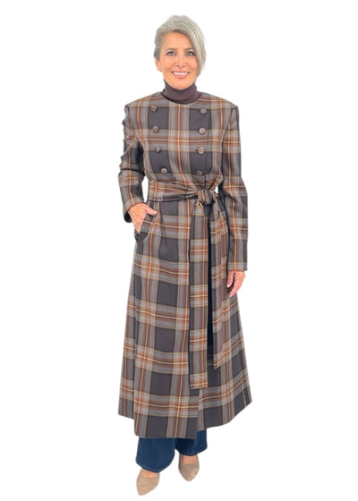 Woman wearing a plaid dress with a belt on a white background